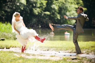 Bride and Groom splashing in puddle Bride and Groom splashing in puddle