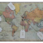 World map seating plan with guest names on luggage labels