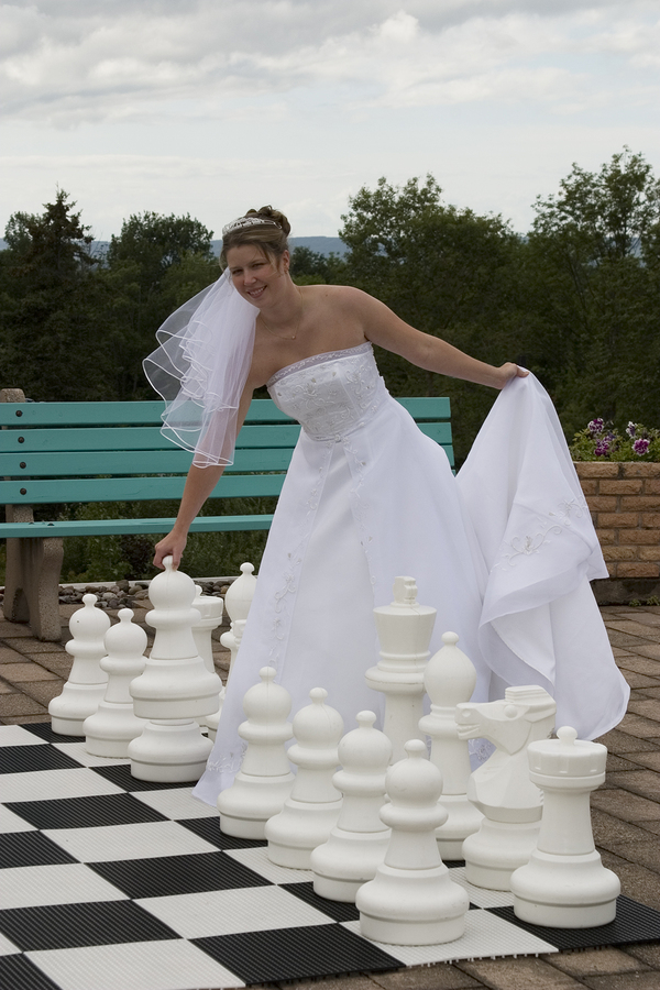Bride playing large chess game
