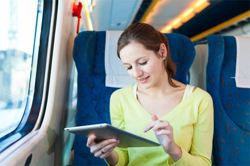 Woman using TopTablePlanner on a tablet computer on the train